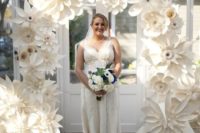 12 an oversized ivory paper flower arch for the wedding ceremony