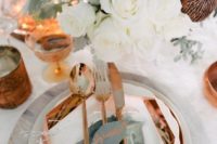 13 a glam place setting with lush white blooms, copper cutlery and a charger and glasses