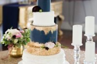 13 a wedding cake with navy and gold glitter layers and whites for a contrast