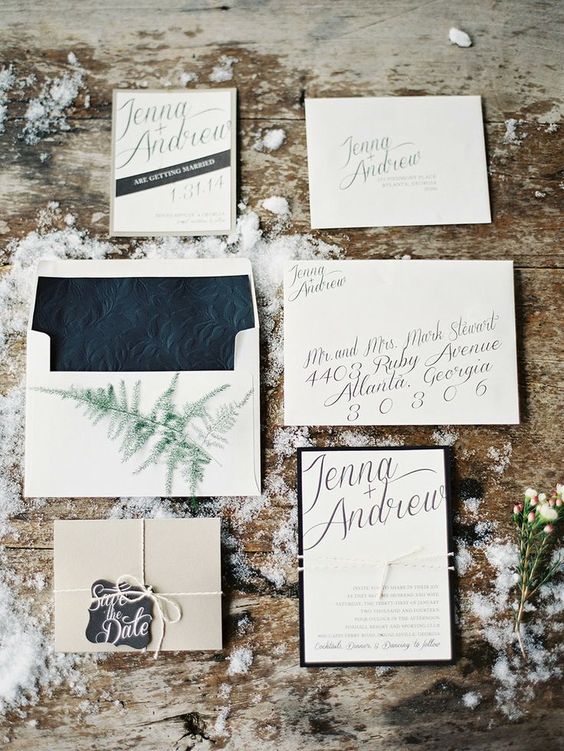 neutral and black winter wedding invitation set with pressed lining and evergreen prints