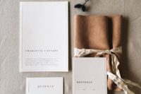 13 neutral wedding invitations wrapped with faux leather to add an eye-catchy touch