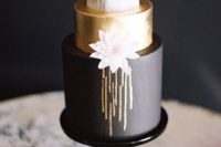 14 a chic wedding cake with a black, gold and marble layer topped with a geode for an art deco winter wedding