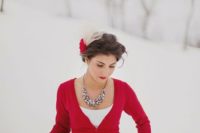 15 a short red cardigan and a statement necklace help to accessorize the wedding dress