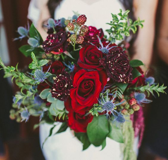 deep red and burgundy bouquet with unique roses, thistles, greenery and berries for a bold touch