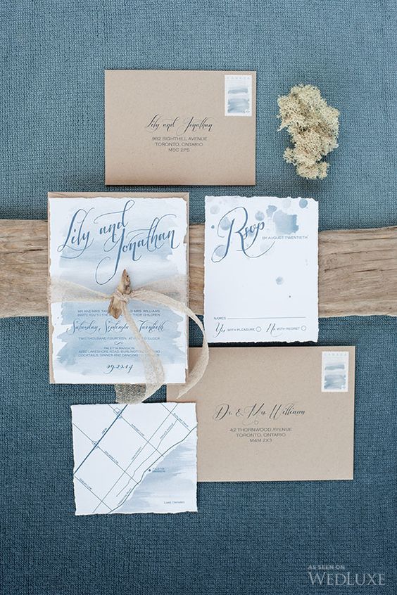 ethereal blue watercolor wedding invies with a raw edge and kraft paper envelopes