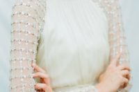 16 a modern wedding gown with embellished sleeves will keep you warm and stylish at the same time