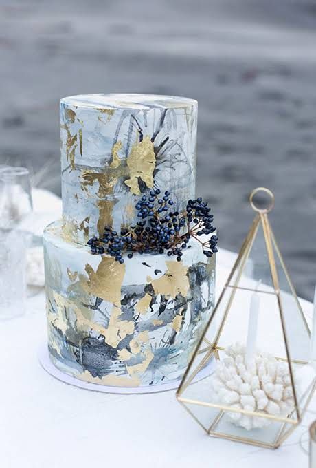 a crazy marbeleized and watercolro splash wedding cake with gold leaf and berries