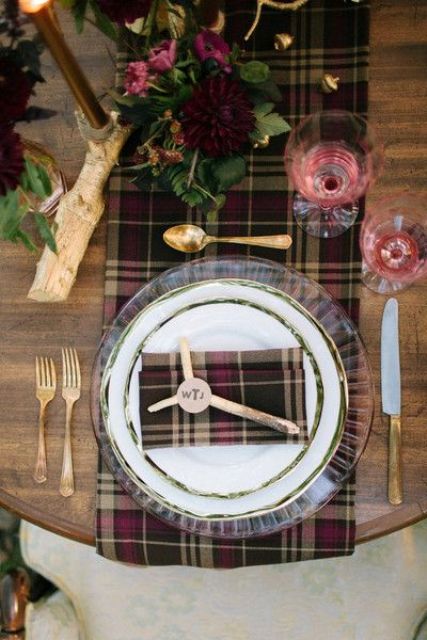 a plaid table runner and napkin in darker colors are amazing for a rustic and woodland winter wedding