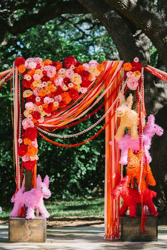 a super fun piñata, streamer and paper flower wedding canopy for a Mexico-inspired wedding