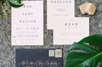 17 modern neutral invitations and a black envelope with copper celligraphy