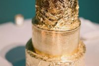 18 a glam gold leaf cake with two textural layers is a chic idea for a glam or New Year’s wedding