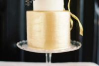 19 an elegant white and gold wedidng cake topped with a berry branch for a chic winter wedding