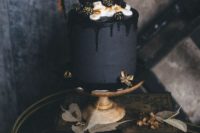 20 a matte black wedding cake with chocolate shards, gilded blackberries and cream