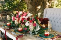 20 an outdoor winter wedding tablescape with lush pink and white blooms, gilded pomegranates and chargers, vintage upholstered furniture