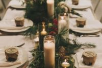 20 evergreens, pinecones, red leaves and lots of candles for a forest winter wedding