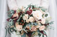 21 a lush bouquet with blush roses, berries, eucalyptus and bold foliage