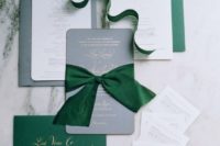21 grey, white and emerald invitations with gold calligraphy and large bows remind of Christmas
