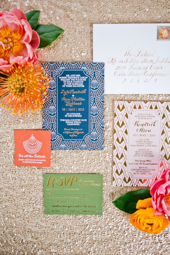 a glam art deco wedding invitation suite in blue, green and red with calligraphy