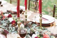 22 a greenery table runner with berries and plum blooms and fuchsia candles for a bold festive runner
