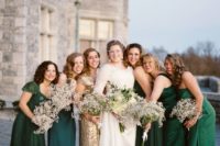 22 bridesmaids wearing emerald dresses and the maid of honor in a gold sequin gown