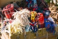 22 offer your guests to snuggle up into cozy plaid pashminas and scarves to feel warm during an outdoor ceremony