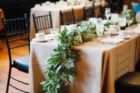 23 a lush cascading greenery and neutral bloom table runner for a snowy winter wedding