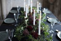 23 an ethereal wedding tablescape with greenery and burgundy blooms and candles