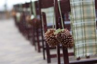 23 green plaid fabric and oversized pinecones for decorating the aisle