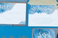 23 ice blue wedding invitation suite with swirly frosty prints and calligraphy