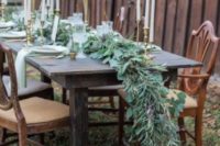 24 a lush cascading greenery table runner for a rustic winter tablescape and matching centerpieces