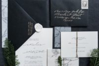 25 a black and white invitation suite with calligraphy and botanical silhouettes for a modern organnic wedding