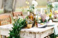 26 a lush greenery table runner with bold blooms and gilded candle holders for an eclectic tablescape