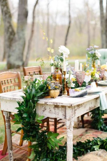 a lush greenery table runner with bold blooms and gilded candle holders for an eclectic tablescape