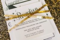 26 a modern black and white invitation set wrapped with gold sequins