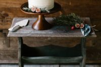 28 a simple textural white wedding cake with figs and evergreens