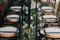 31 foliage and white blooms table runner with black candles for an elegant forest-themed winter wedding