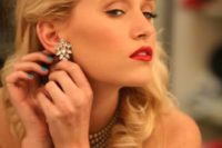 02 1940s glam makeup with a red lip, vintage waves and statement rhinestone earrings