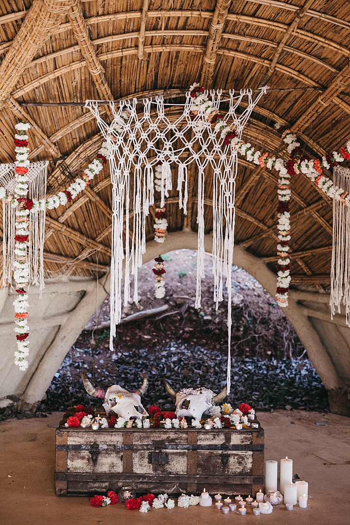 A macrame wedding backdrop was done by the phtographer and floral garlands all around reminded of Indian garlands that are traditional for weddings