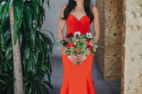 02 The bride was wearing a fiery red wedding dress with a mermaid silhouette, a train, a sweetheart neckline and a button row on the bodice