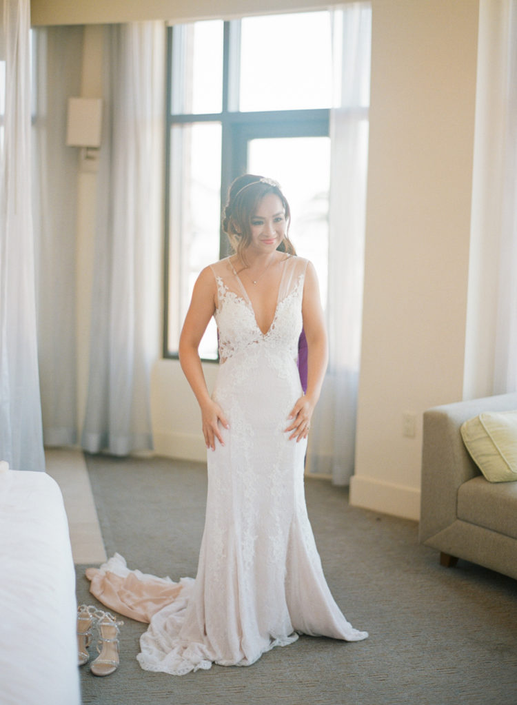 The bride was wearing a plunging neckline wedding dress with an illusion bodice, shoulders and back