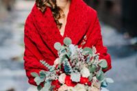 02 a bold red knit wrap and a greenery and red bouquet for a Christmas bride