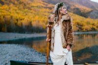 03 a boho lace wedding dress, a faux fur coat, a greenery crown and brown leather boots for a boho bride