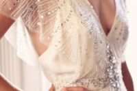 03 a bold beaded art deco wedding dress with a plunging neckline and flowy sheer sleeves
