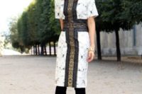03 a gorgeous white printed knee dress with short sleeves, a large gold and black cross and black suede boots
