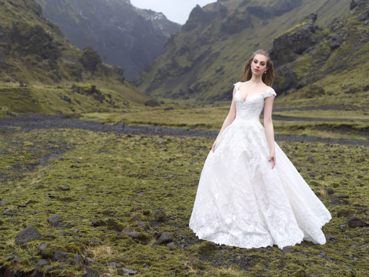 An off the shoulder wedding gown with textural lace and A-line looks princess-like