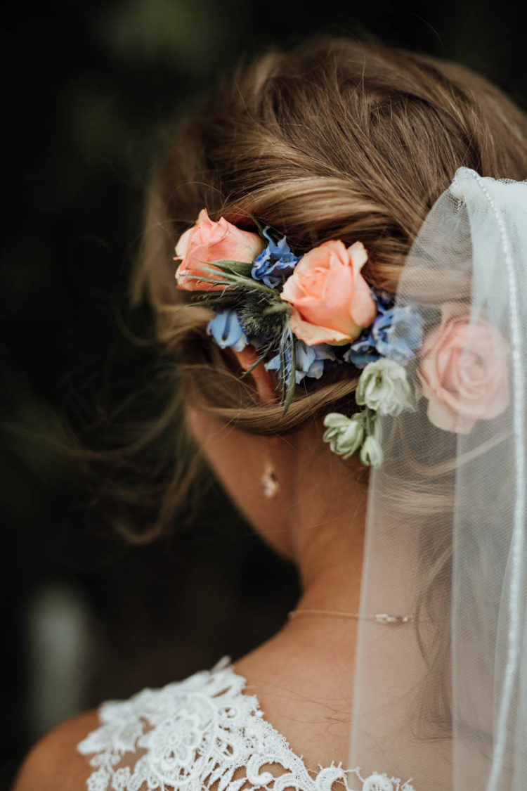Coral and blue flowers were incorporated into the bridal hair