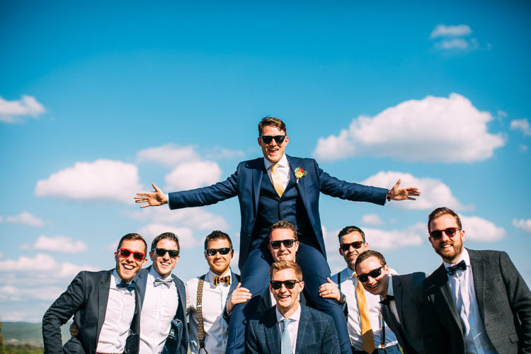 The groomsmen were waering blue and grey suits with bow ties of their choice