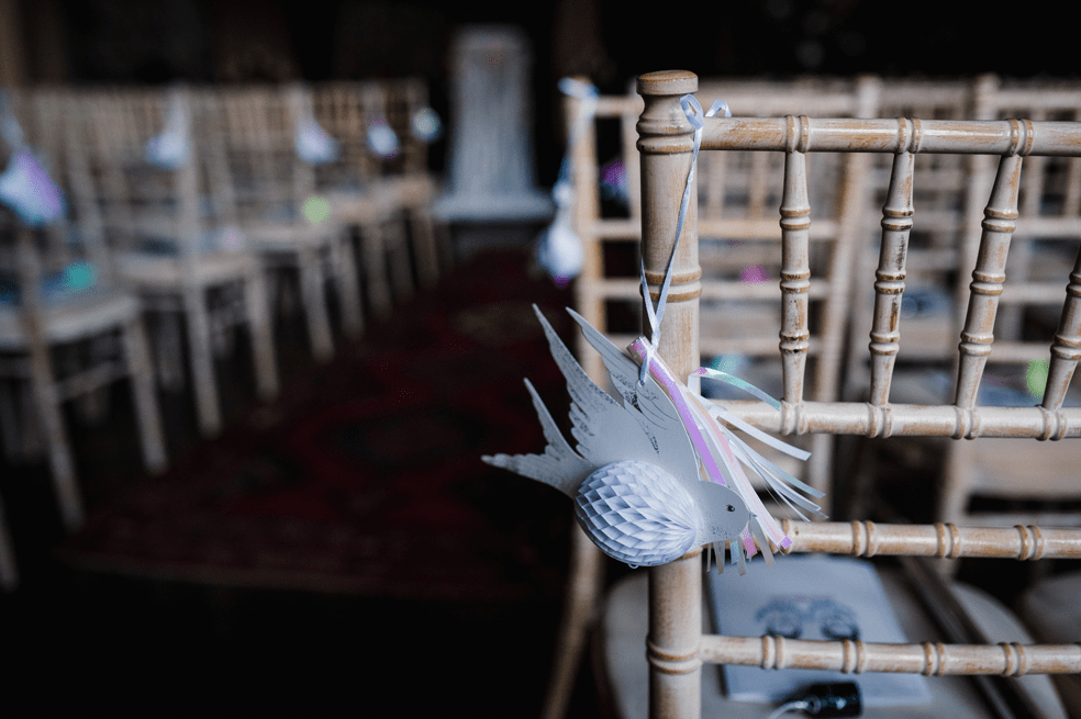 The wedding aisle was decorated with paper birds and fringe