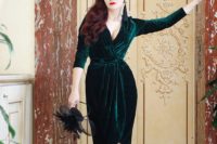 04 a gorgeous wrap emerald velvet dress with a plunging neckline, half sleeves, with buttons and black shoes and tassel earrings