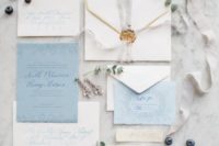 04 neutral and blue wedding stationery with ethereal ribbons, a raw edge and seals